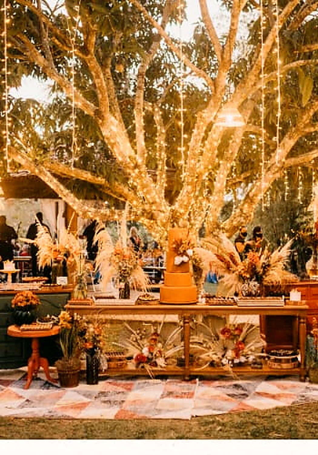 Reception décor with pampas grass and festoon lighting