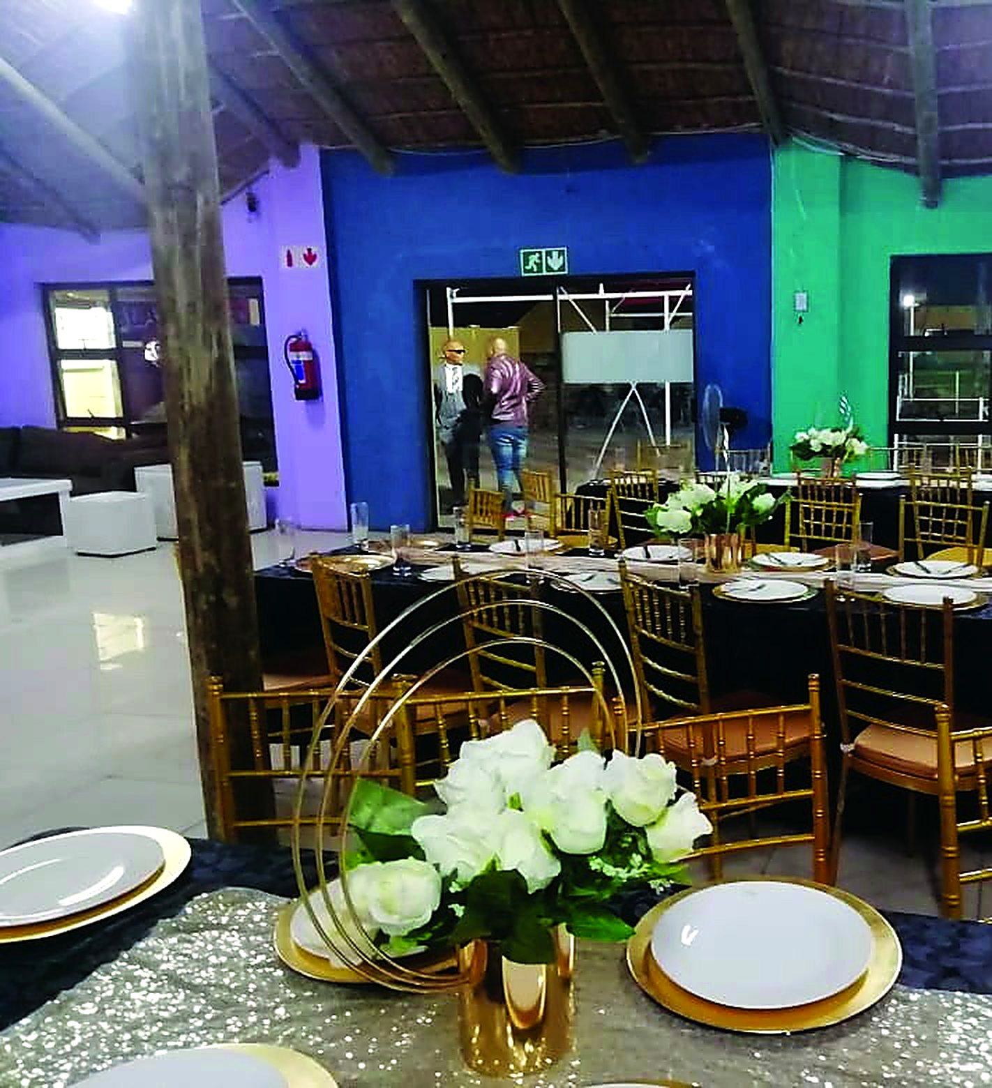 A hall set up with round tables and place settings